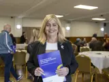 Sue Fletcher from Age UK holding a copy of the report
